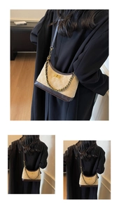 Macro detail of quilted fabric texture and gold rotating buckle on retro crossbody bag