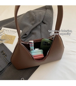 Brown lychee leather hobo bag showing internal capacity for phone and small pouches