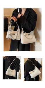 Detailed view of white pleated hobo bags with silver chains and mini pendant charm