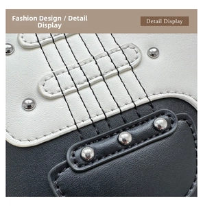 Detail display of guitar-shaped crossbody bag featuring silver rivets and violin string stitching