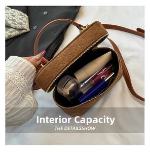 Detail view showing internal capacity of the brown quilted bucket bag with cosmetics