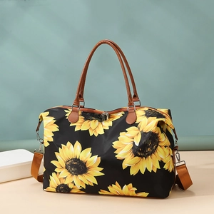 Detail of sunflower travel tote with brown leather handles and waterproof nylon fabric
