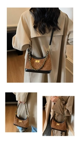 Close-up of brown quilted crossbody bag with gold rotating lock and braided chain strap