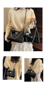 Close-up of black patent leather shoulder bag with bold silver chain and mini pouch detail