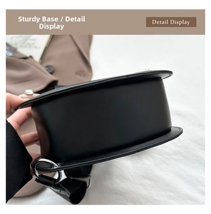 Close-up of the sturdy base and metal ring connection on the violin-shaped shoulder bag