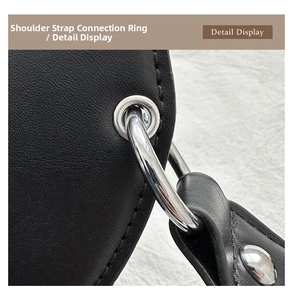 Detail of lychee pattern leather shoulder strap connection with silver metal eyelets