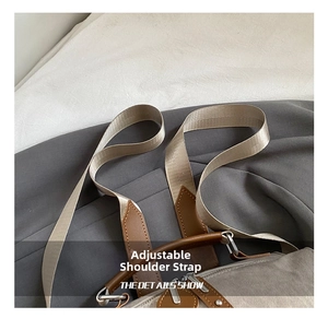 Detail show of the adjustable fabric shoulder strap and leather attachment on the canvas bag