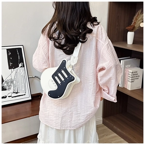 Fashionable electric guitar shaped crossbody bag with wide strap on model back view