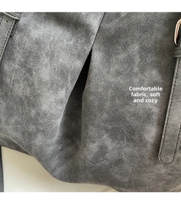 Detail of the high-quality grey frosted leather fabric and stitching on the tote bag