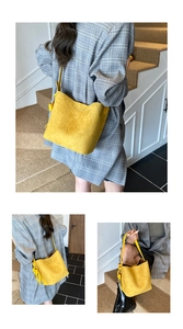 Three-way view of yellow suede bucket bag with long strap and fringe tassel charm