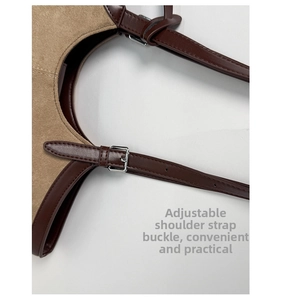 Close-up of adjustable silver buckle and stitching on vintage suede shoulder bag strap