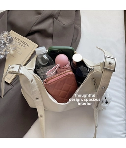Top view of creamy white hobo bag showing large storage capacity and interior organization