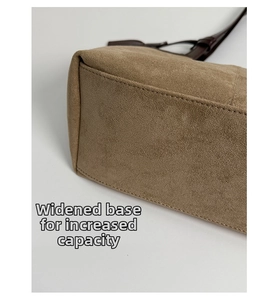 Macro detail of the widened bottom of the suede tote bag with reinforced stitching