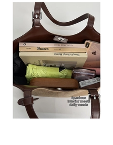 Top view of spacious tote bag interior filled with books, umbrella, and daily essentials