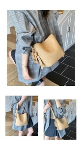 Three-way view of a khaki suede bucket bag with knotted straps and a gold lock pendant