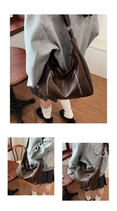 Macro shot of dark brown PU leather hobo bag with vintage texture and silver zippers