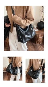 Close-up of black retro oversized hobo bag with dual decorative silver zippers for women