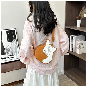 Unique guitar shaped crossbody bag in brown and white contrast color with metal rivets and details.