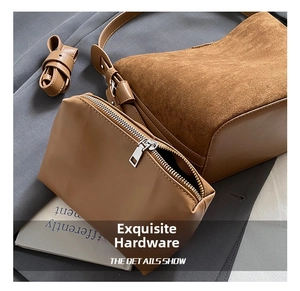 Close-up of caramel bucket bag set with textured leather stitching and hardware