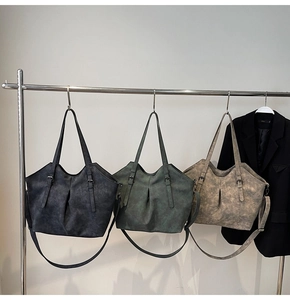Three large tote bags in black, green, and tan with textured matte vegan leather finish