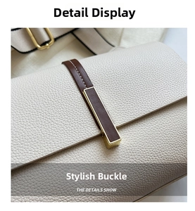 Detail of lychee pattern leather bag with gold buckle and brown strap contrast