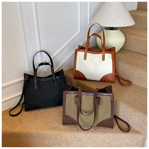 Détails de trois grands sacs cabas en toile et cuir présentés sur des escaliers