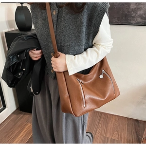 Brown vintage faux leather tote bag with dual front silver zippers and long shoulder strap