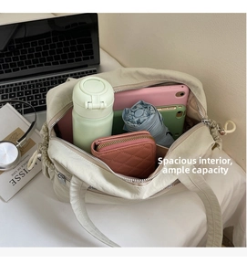 Spacious tote bag interior showing capacity for laptops, tablet, water bottle and umbrella