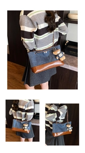 Detail of color-block denim tote with gold chain strap and bear charm accessory