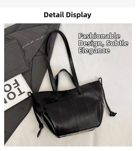 Detail of black glossy tote bag featuring vertical quilted texture and drawstring accents