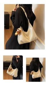 Détail du sac demi-lune blanc crème en similicuir avec charm ours et zip à pampilles
