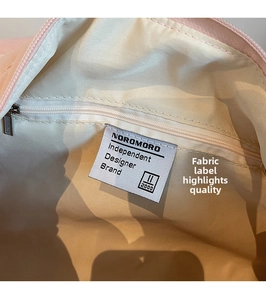 Detailed view of striped travel bag interior featuring premium lining and zipper pocket