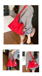Close-up of red tote bag with decorative charms and soft matte texture detail