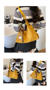 Detail of yellow suede tote bag with silk scarf handle and coffee cup charm decoration