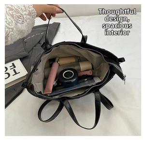 Interior view of black faux leather tote bag showing spacious storage for cosmetics