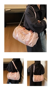 Detail of pink quilted sports bag showing soft nylon texture and adjustable shoulder strap