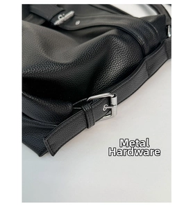 Close-up of silver metal buckle on black lychee grain faux leather tote bag detail