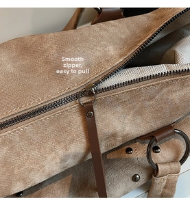 Detail of smooth metal zipper and premium canvas texture on khaki tote bag