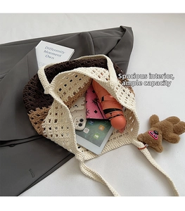 Interior detail of large woven tote bag showing storage for tablet, wallet, and umbrella