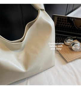 Beige soft faux leather hobo bag with knotted strap handle and urban lifestyle accessories
