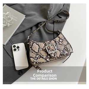 Detail of snake skin pattern handbag with metal buckle on a grey blazer background