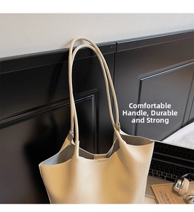 Close-up of beige lychee grain leather tote bag with durable handles and spacious interior