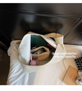 Spacious interior of off-white tote bag showing umbrella and digital tablet storage