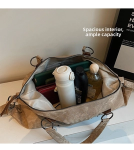 Top down view of spacious tote interior with leather trim, tablet, and travel essentials