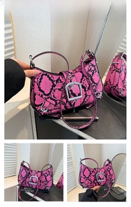 Detail of rose red snake-pattern hobo bag featuring silver buckles and adjustable strap