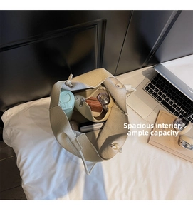Detailed interior of the beige tote bag showing large capacity and lychee pattern leather