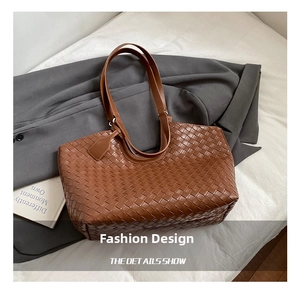 Close-up of brown woven leather tote bag showing intricate craftsmanship and luxury texture