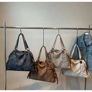 Detail of vintage rivet tote bags showing black, brown, khaki, and beige color options