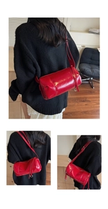 Detailansicht einer glänzend roten Zylindertasche, getragen von einem Modell im Innenraum