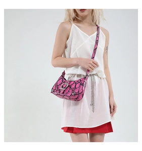 Detailed view of pink snakeskin shoulder bag with silver metallic rivets and Y2K style